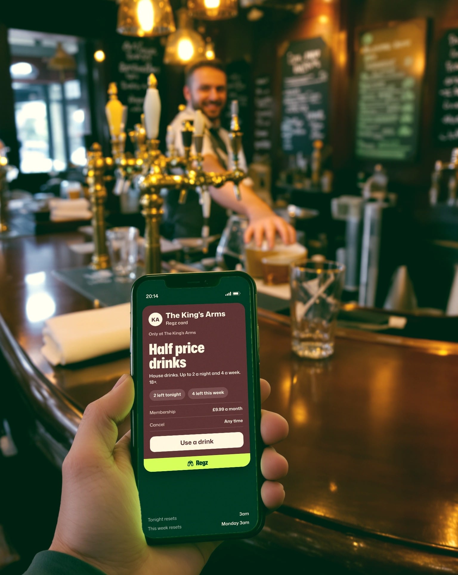 The King's Arms Regz card on a phone held up at the bar, the barman smiling behind